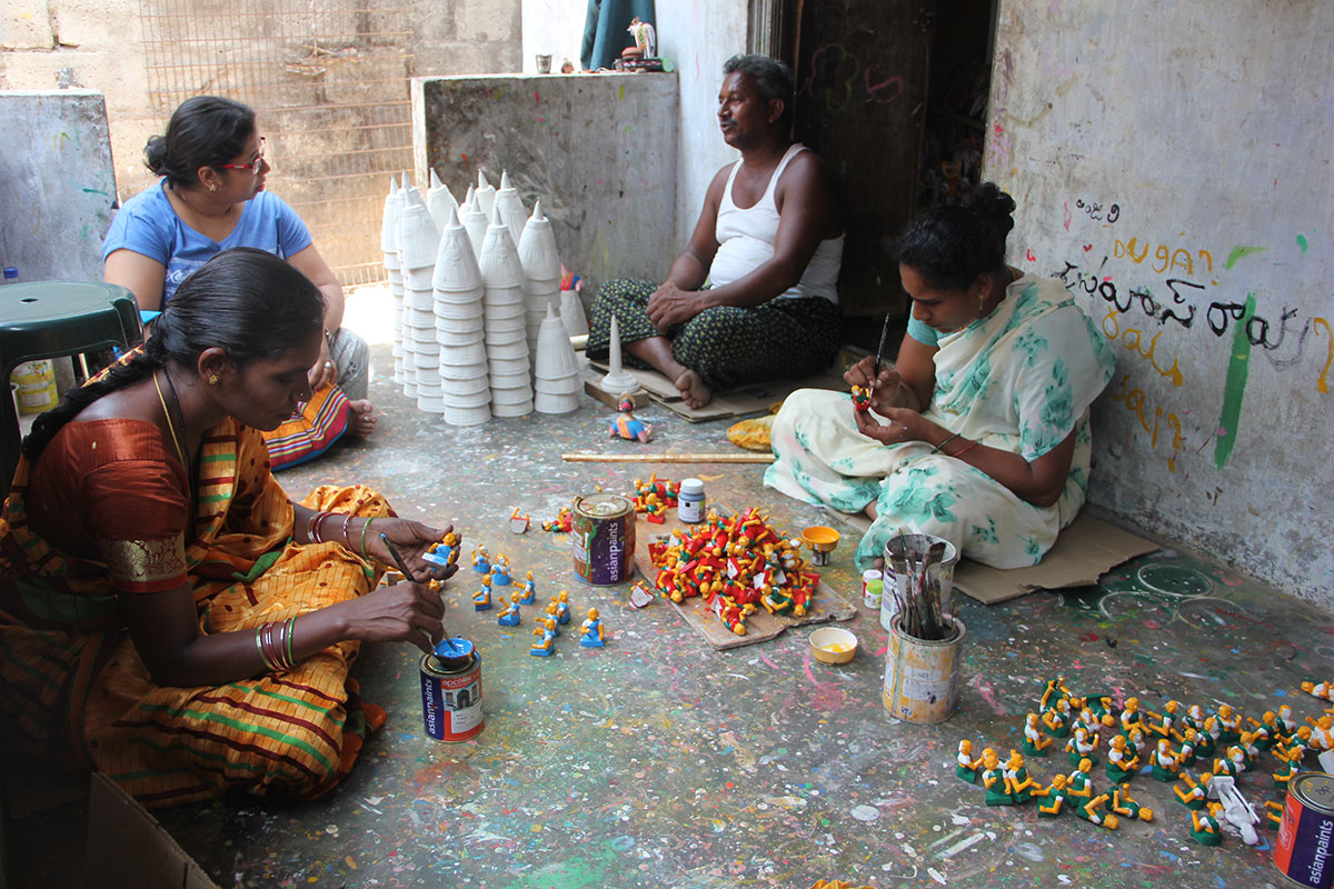 Kondapalli artisans working together among wooden figures
